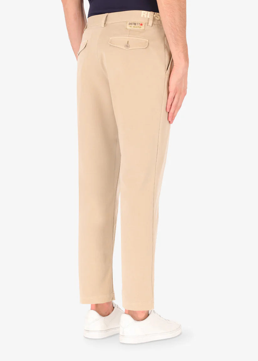 A back image of a model wearing reshaped chinos in tan from Distretto 12.
