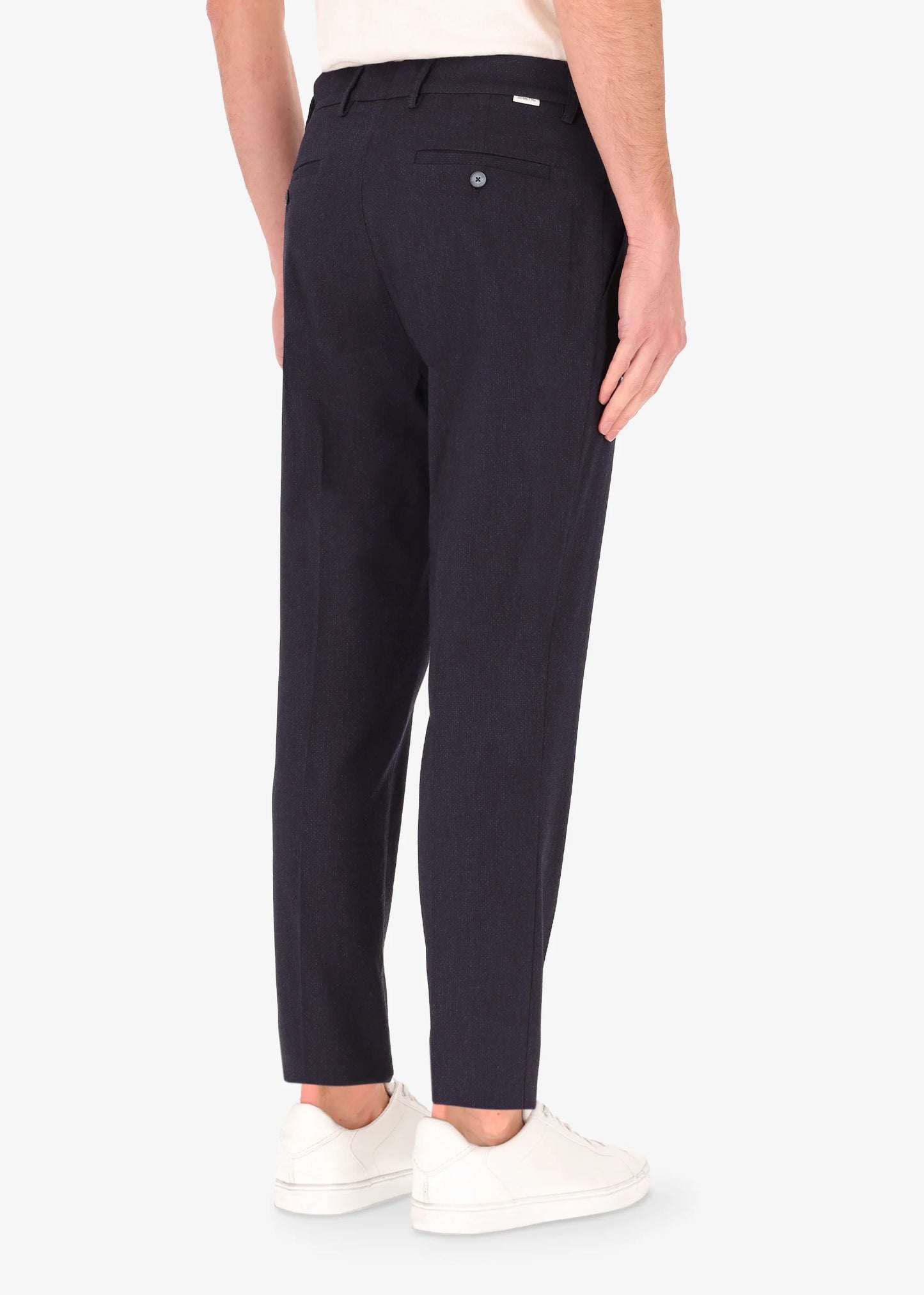 A back facing image of a model wearing the 32 York trousers Saul in blue from Distretto 12.