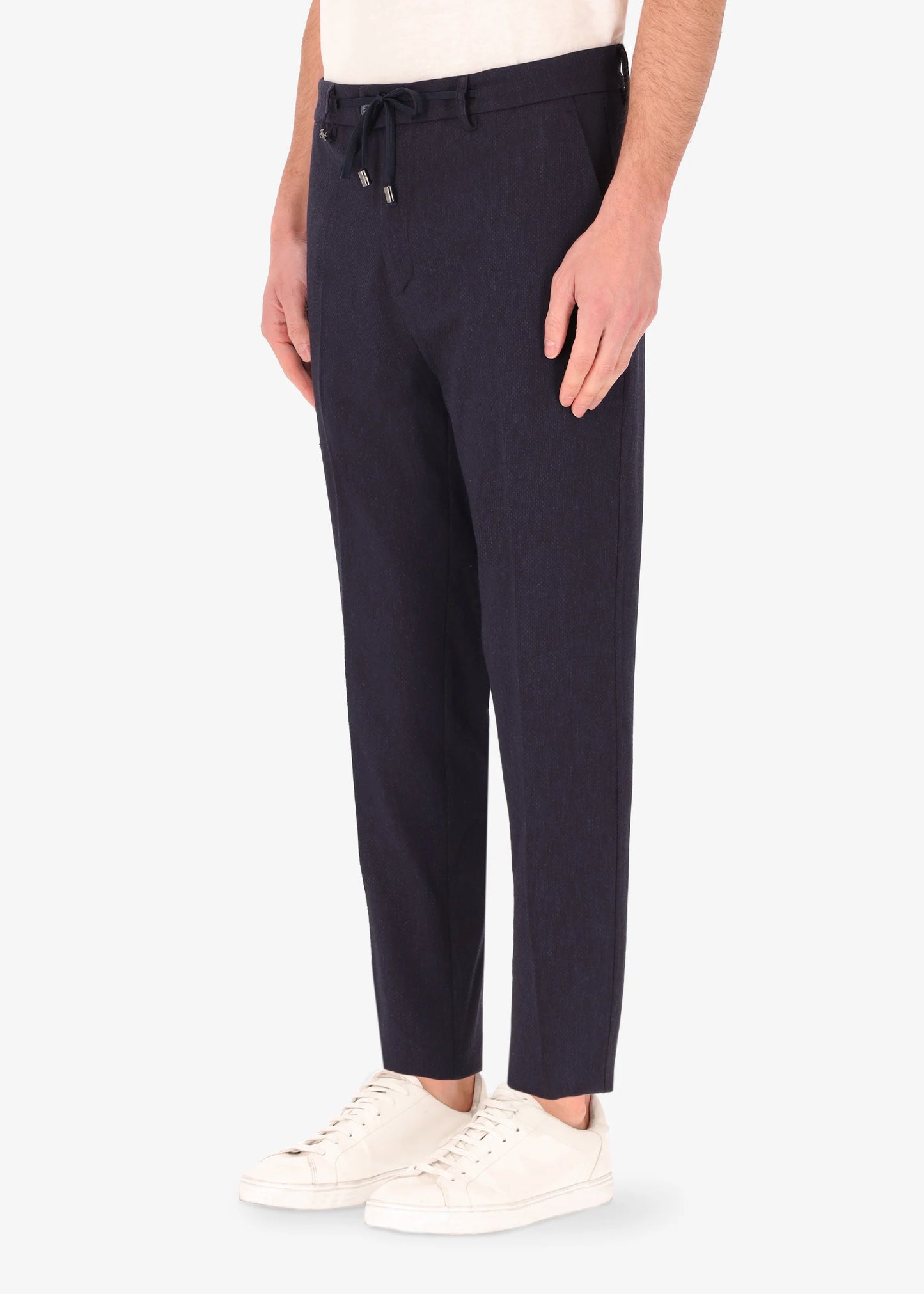 A side facing image of a model wearing the 32 York trousers Saul in blue from Distretto 12.