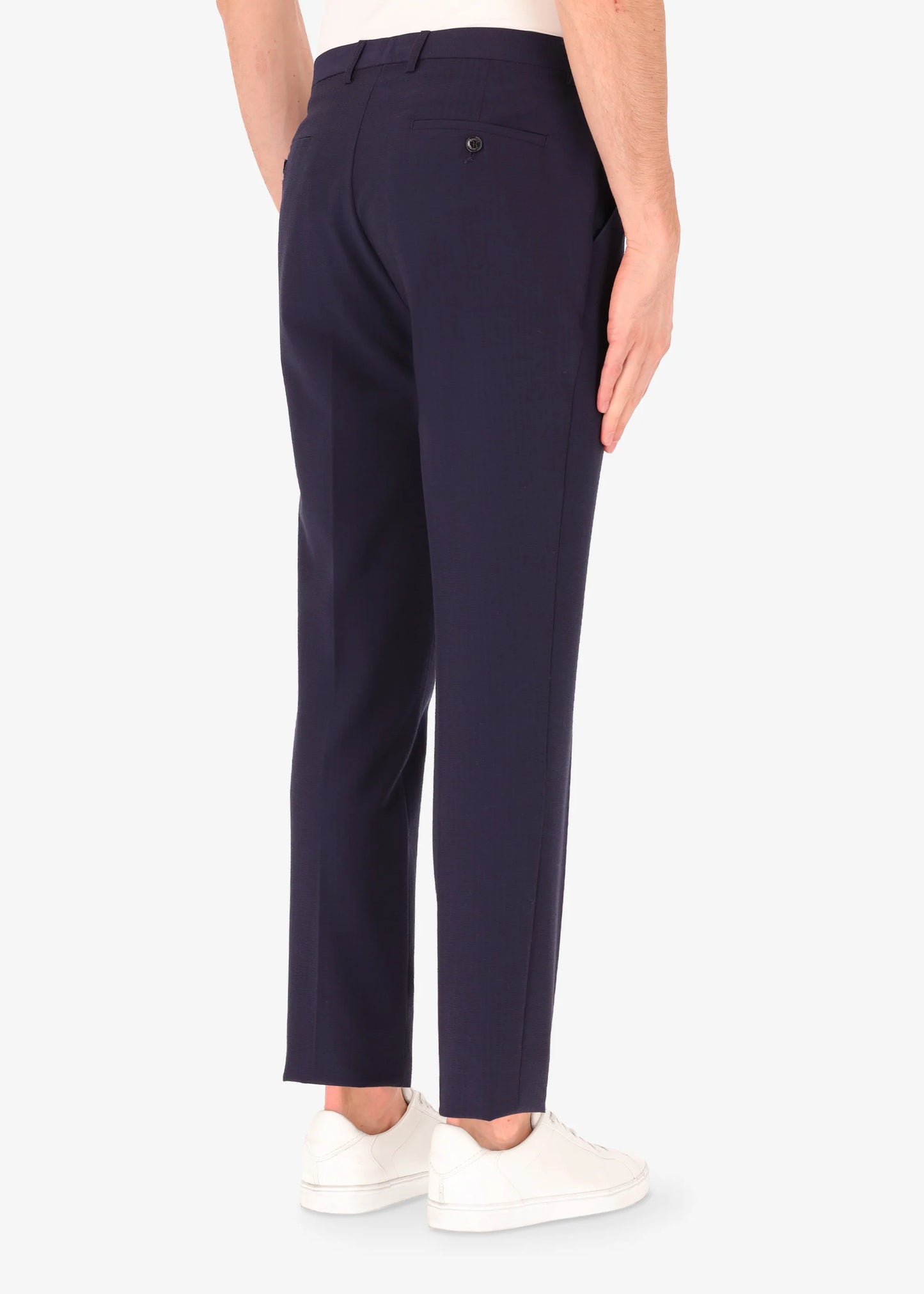 A back facing image of a model wearing Distretto 12 Tailoring tech Firenze Trousers.