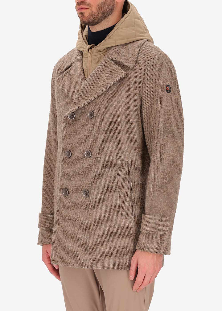 A side image of a model wearing Distretto12 peacoat Bicerin in Dove Grey, with a Dove Grey hood.