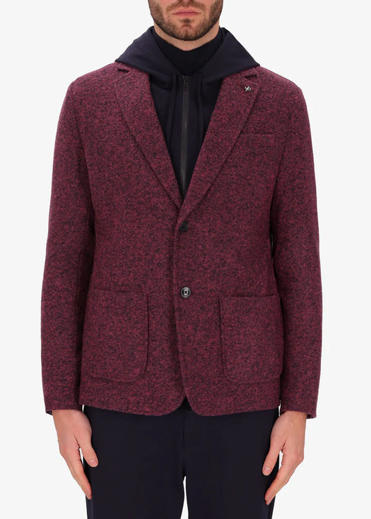 An image of a model wearing a Distretto12 jacket Isaia in mahogany with blue hood.