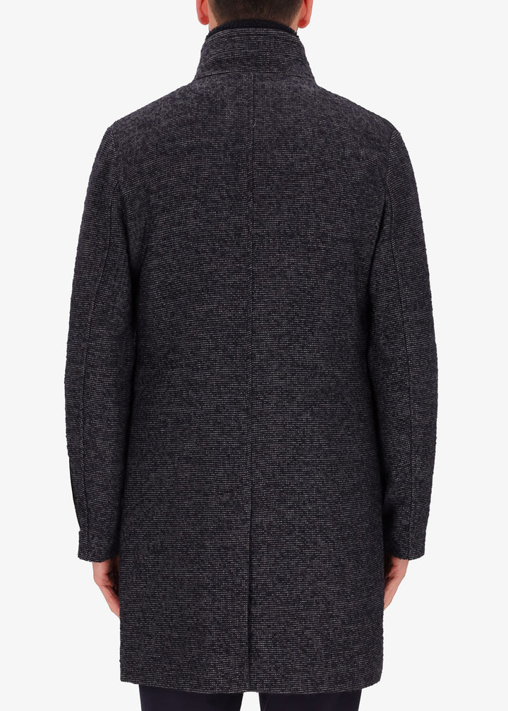 A back image of a model wearing Distretto12 neck coat bicerin in grey with a blue chest insert.