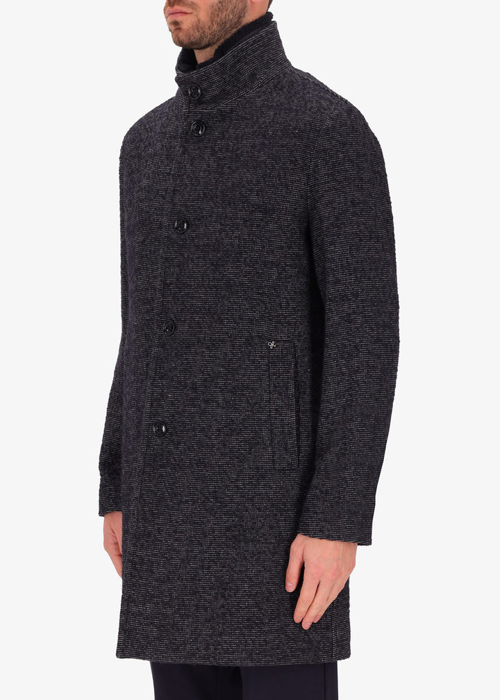 An image of a model wearing Distretto12 neck coat bicerin in grey with a blue chest insert.
