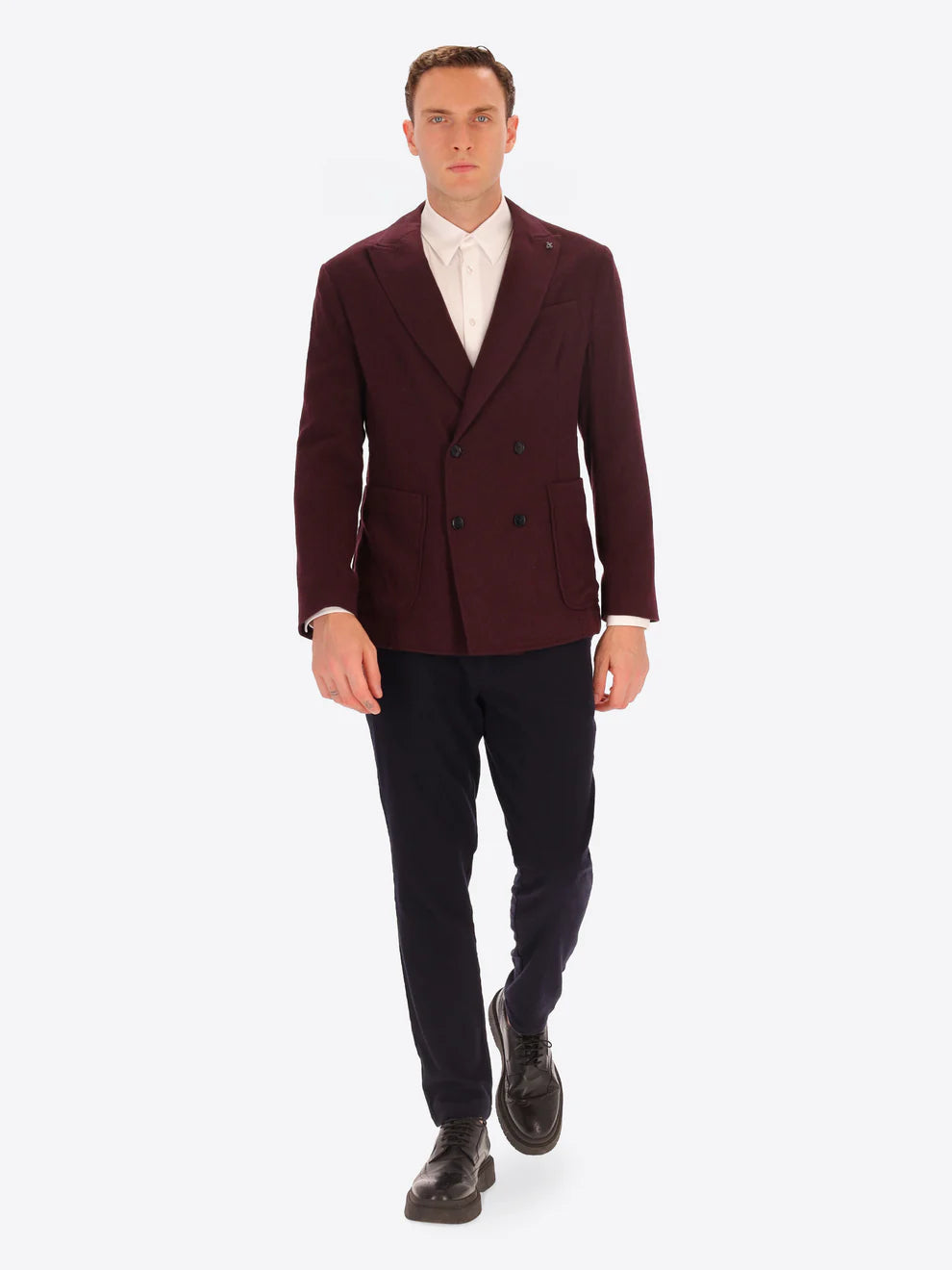 Maroon knitted wool blend Distretto12 double breasted jacket on a male model paired with navy trousers