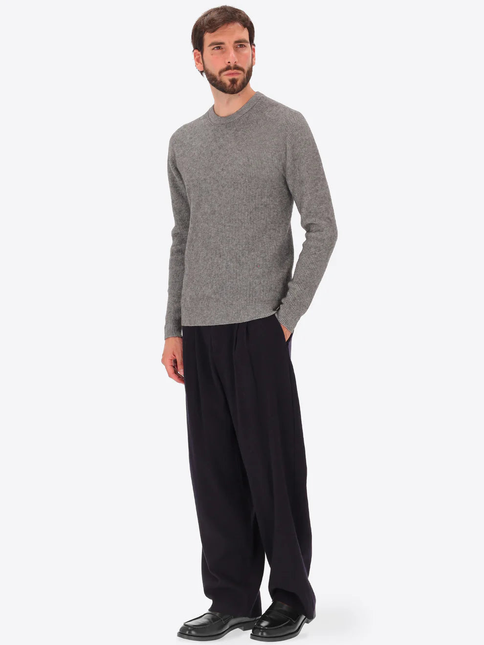 Male model wearing ribbed crew neck knitwear by distretto12 in grey with wide leg trousers
