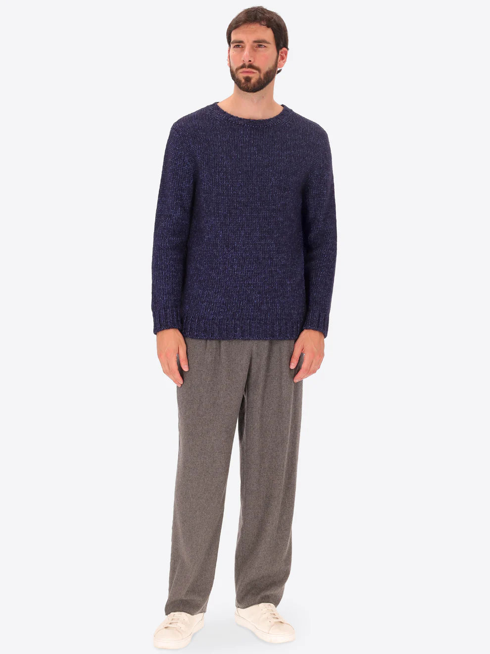 Male model wearing crew neck alpaca blend knitwear by distretto12 in navy with wide leg trousers