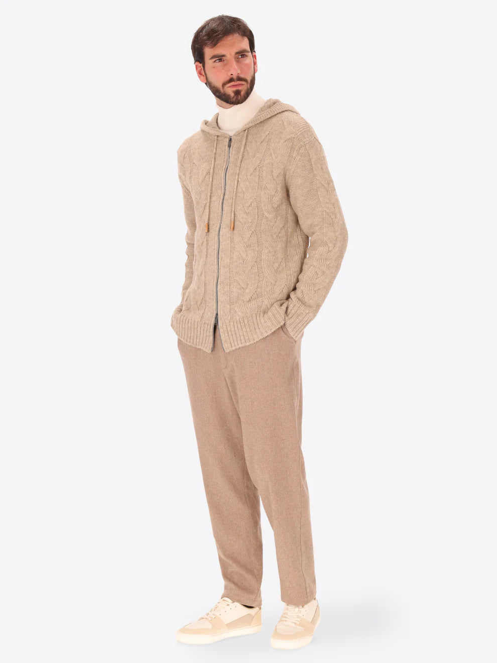 Male model wearing hooded knitwear by distretto12 in dove grey with wide legged trousers