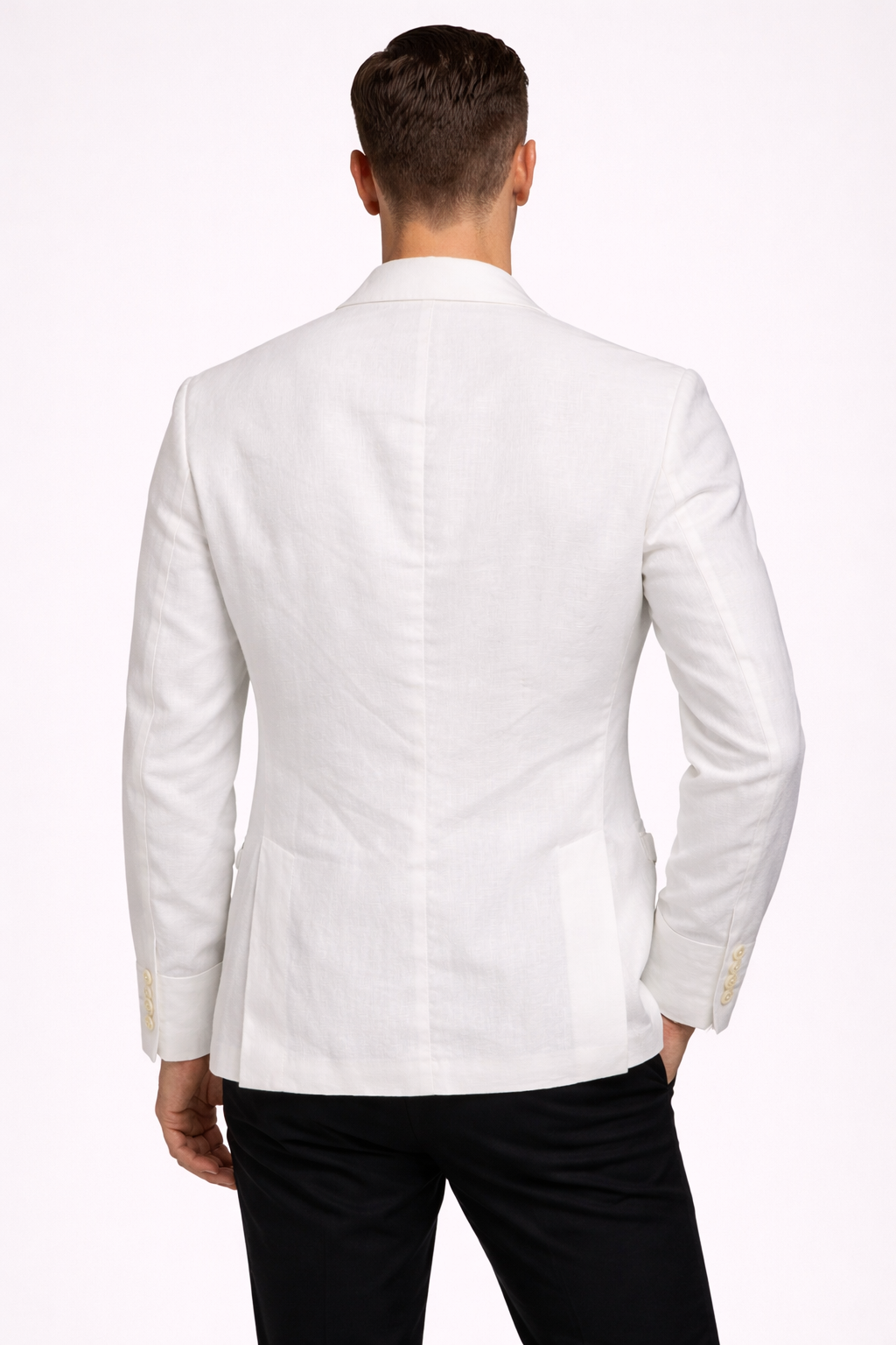 A model wearing a suit from RPL in off white from behind