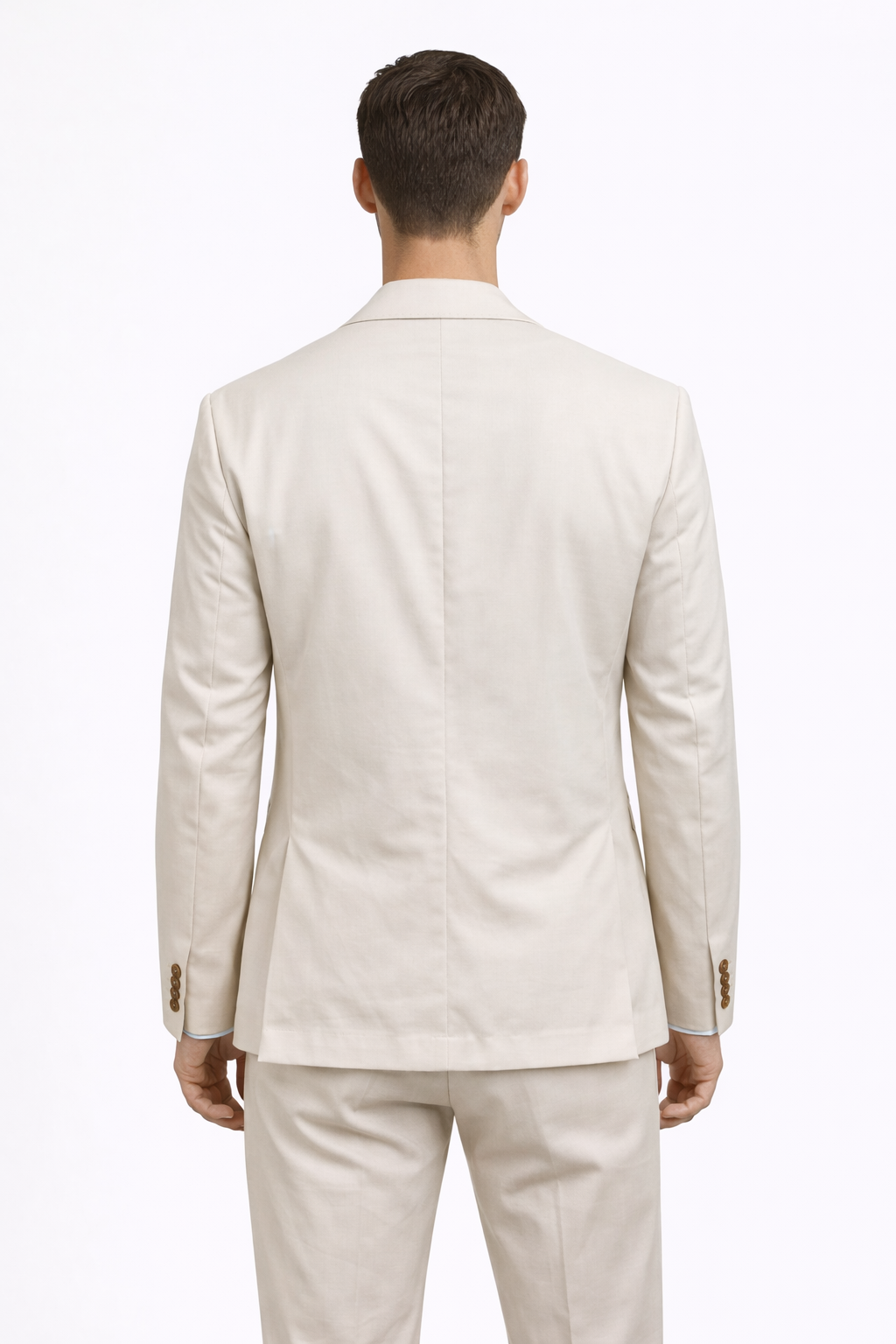 A back facing image of a model wearing a cotton blend double breasted suit from RPL in cream