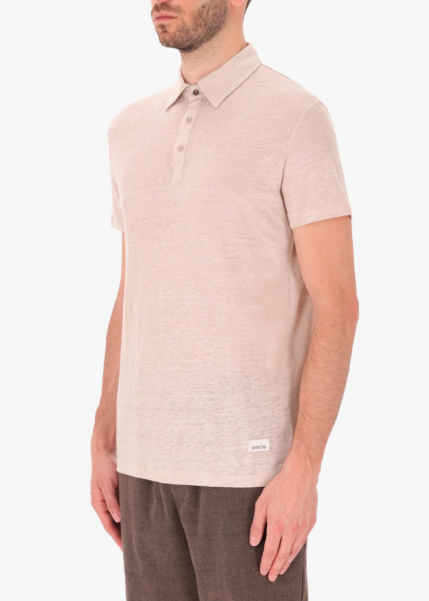 A side facing picture of a model wearing a linen rope coloured polo from Distretto 12.