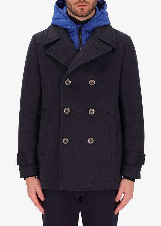 An image of a model wearing a Distretto12 peacoat cruise in blue with blue hood.