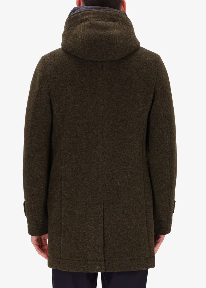 A back image of a model wearing Distretto12 parka coat Valentino in Tobacco, with a blue hood.