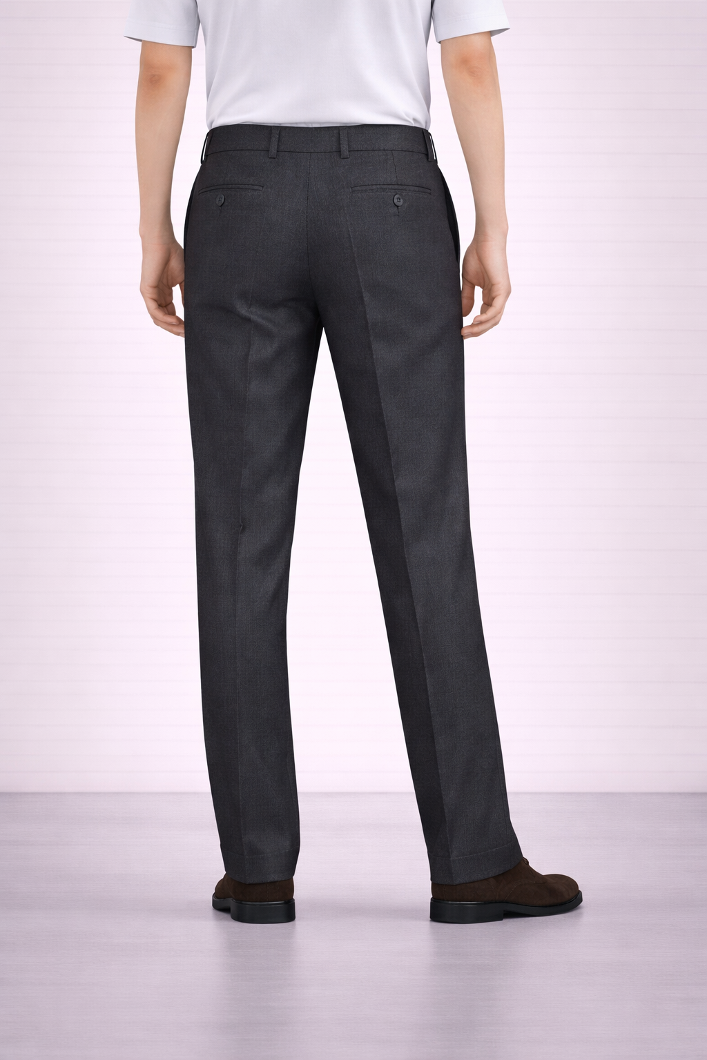 A back angled image of a model wearing Germano 1952 charcoal trousers with slim fit and single pleat.