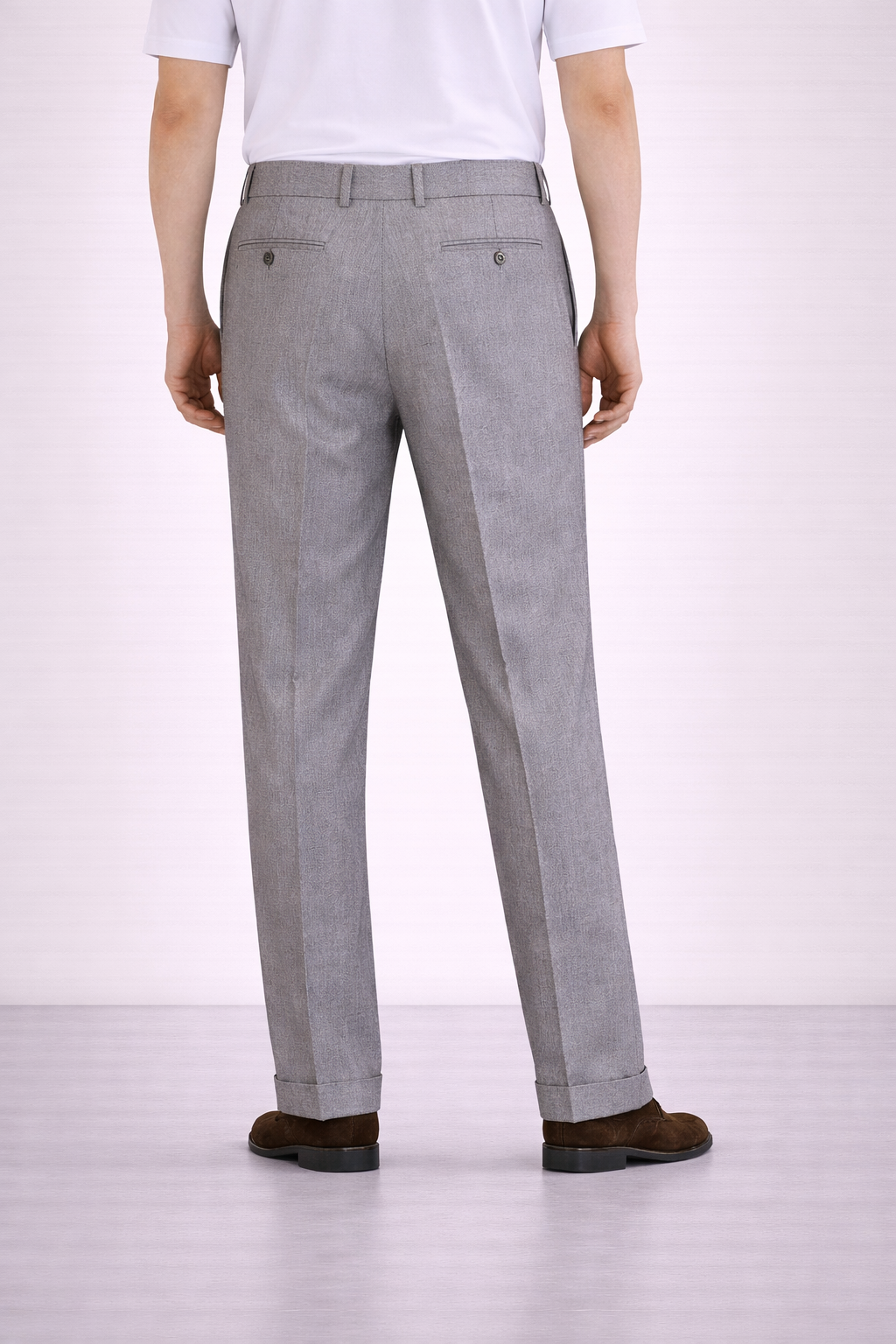 An image of a model wearing Germano 1952 grey trousers with a double pleat taken from a back angle.