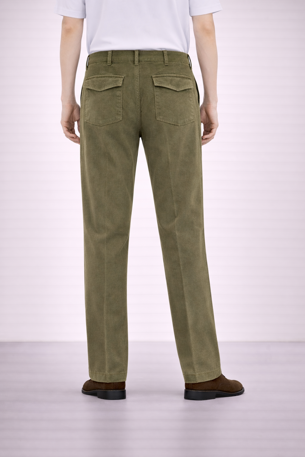 A back angled image of a model wearing Germano 1952 olive moleskin trousers with a single pleat.
