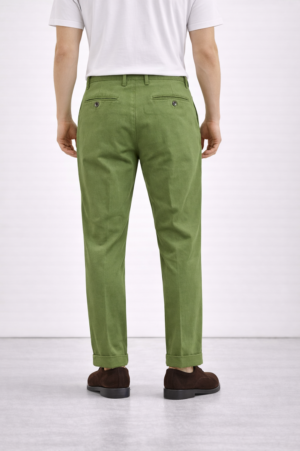 A model wearing Germano 1952 forest green chinos from behind.
