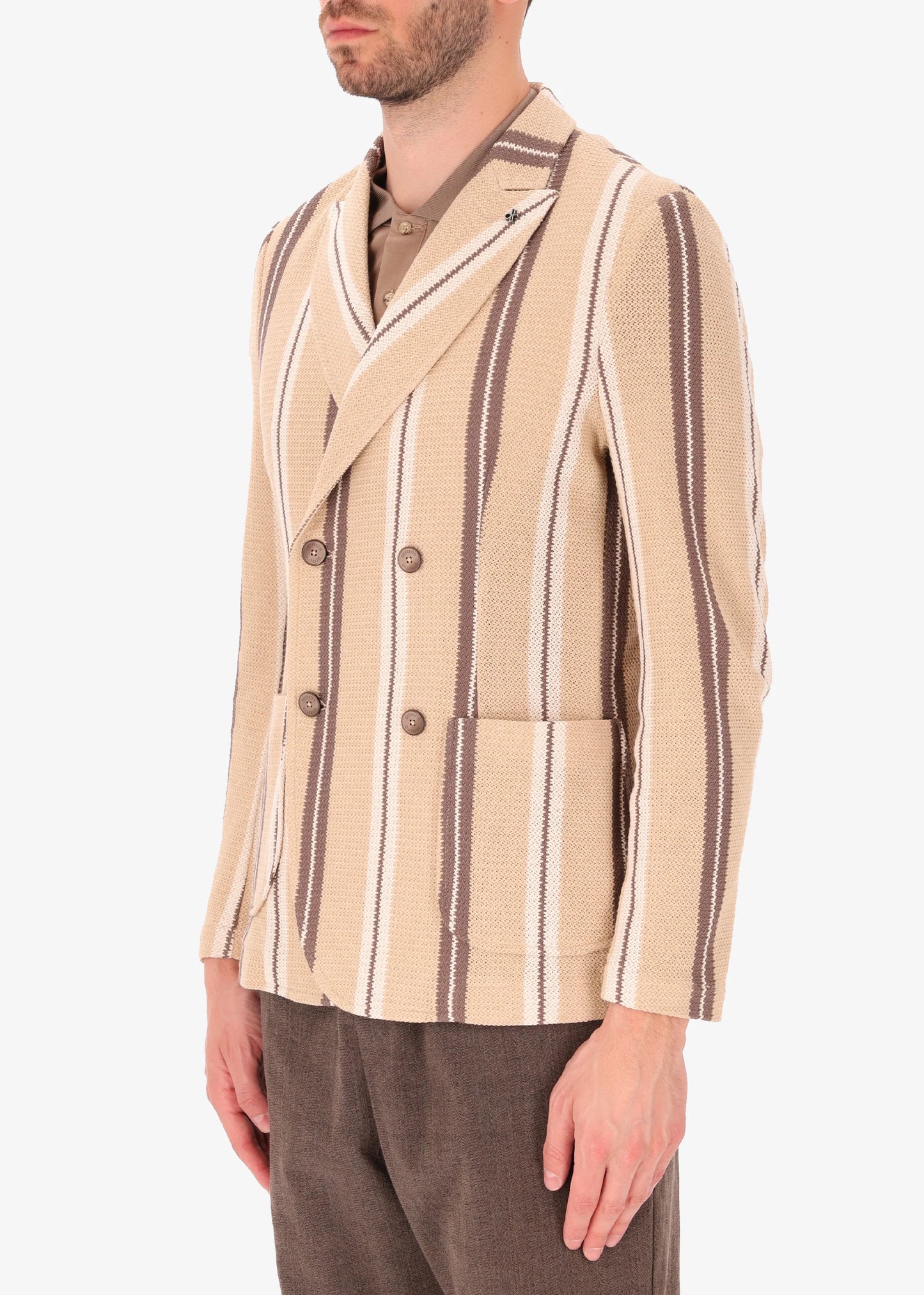 A side facing picture of a model wearing a striped knitted double breasted blazer from Distretto 12.