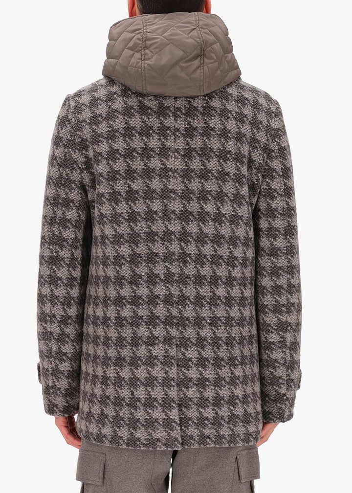 A back facing picture of a model wearing a Distretto12 Peacoat Lingotto in Dove Grey, with a grey hood.