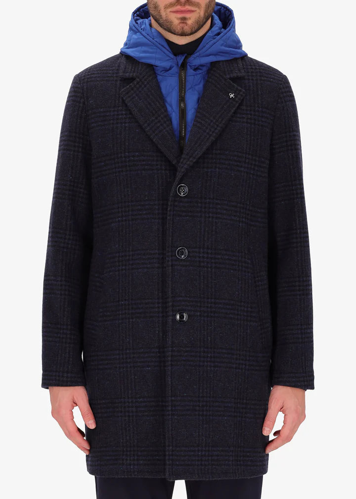 An image of a model wearing a Distretto12 coat Scaglia in blue with light blue hood.