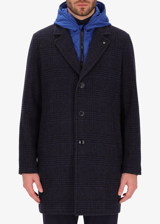 An image of a model wearing a Distretto12 coat Scaglia in blue with light blue hood.