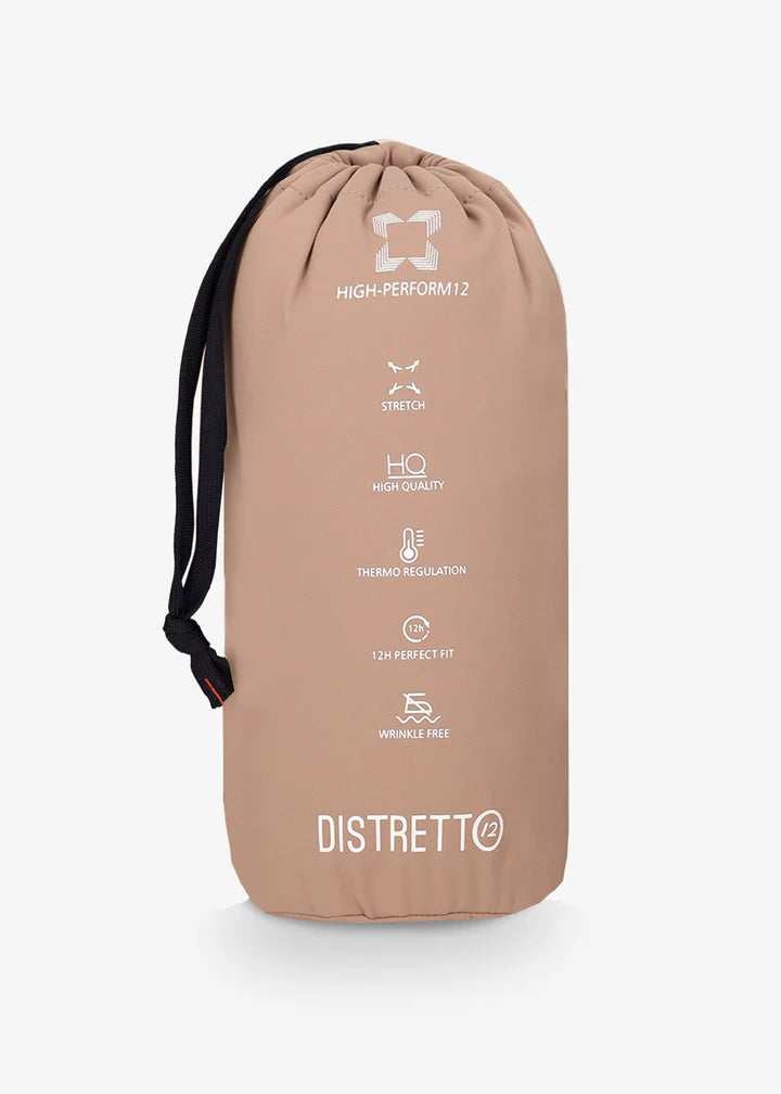 An image of a model wearing a Distretto12 jacket H.P in Sandalwood folded into travel bag.