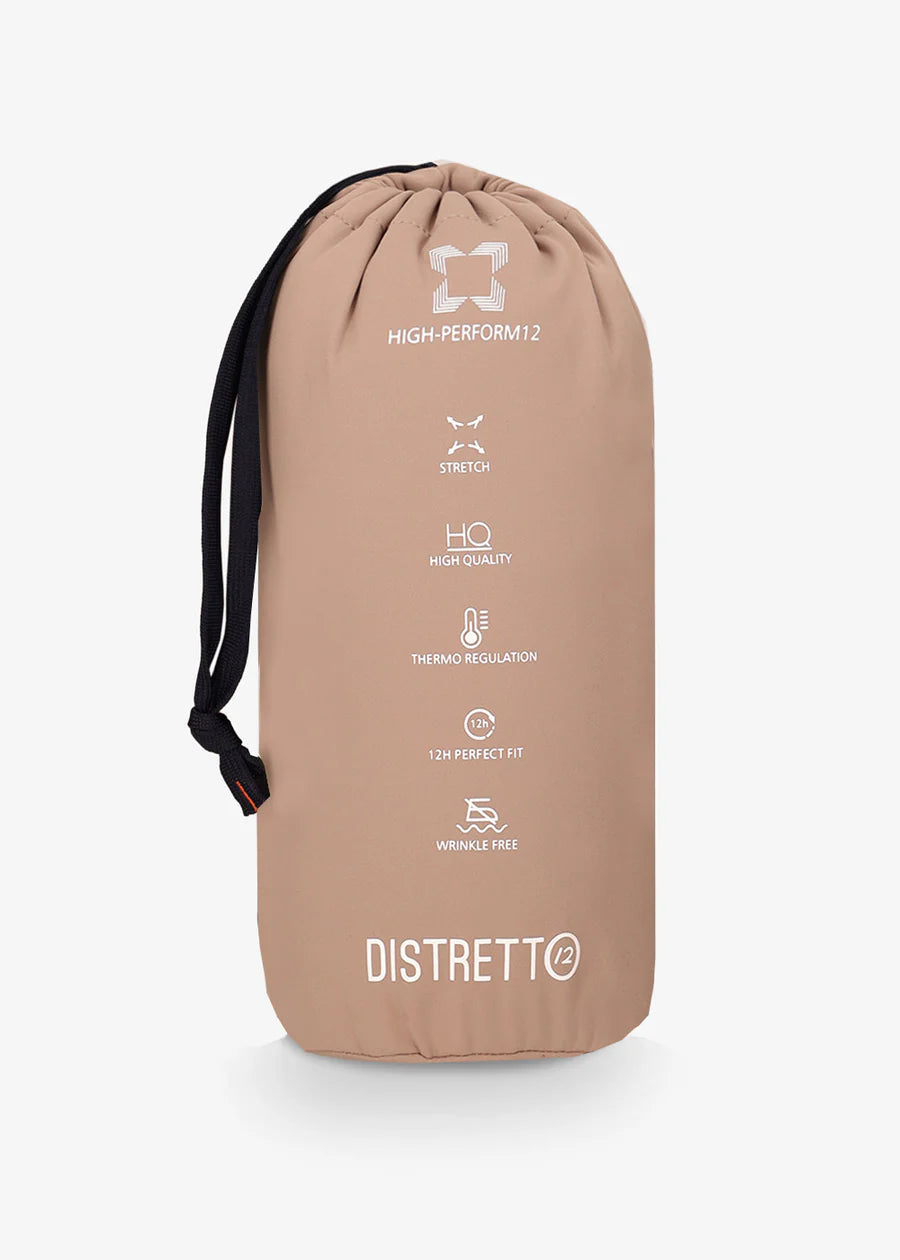 An image of a model wearing a Distretto12 H.P trousers in Sandalwood, folded into travel bag.