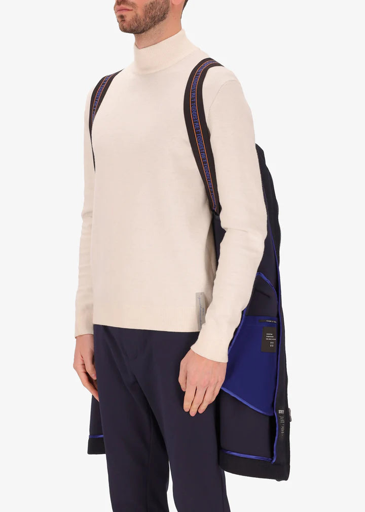 An image of a model wearing Distretto 12 parka coat Carlos in navy by the suspenders.