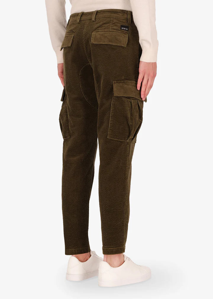 A back facing image of a model wearing Distretto12 corduroy, trousers langa in military.