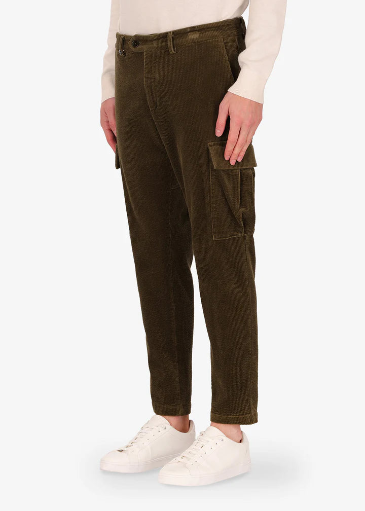 A side facing image of a model wearing Distretto12 corduroy, trousers langa in military.