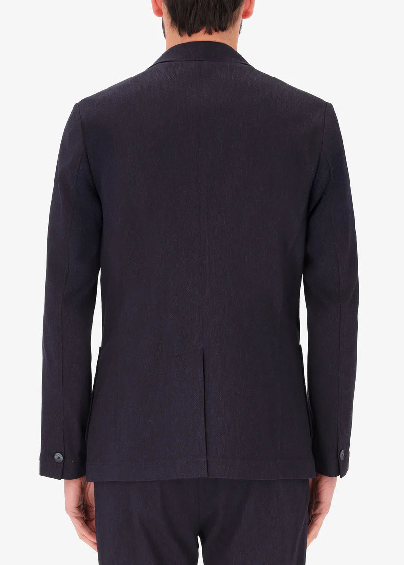 A back facing image of a model wearing Jacket Saul in blue from Distretto 12.