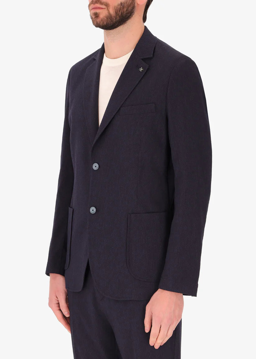 A side facing image of a model wearing Jacket Saul in blue from Distretto 12.