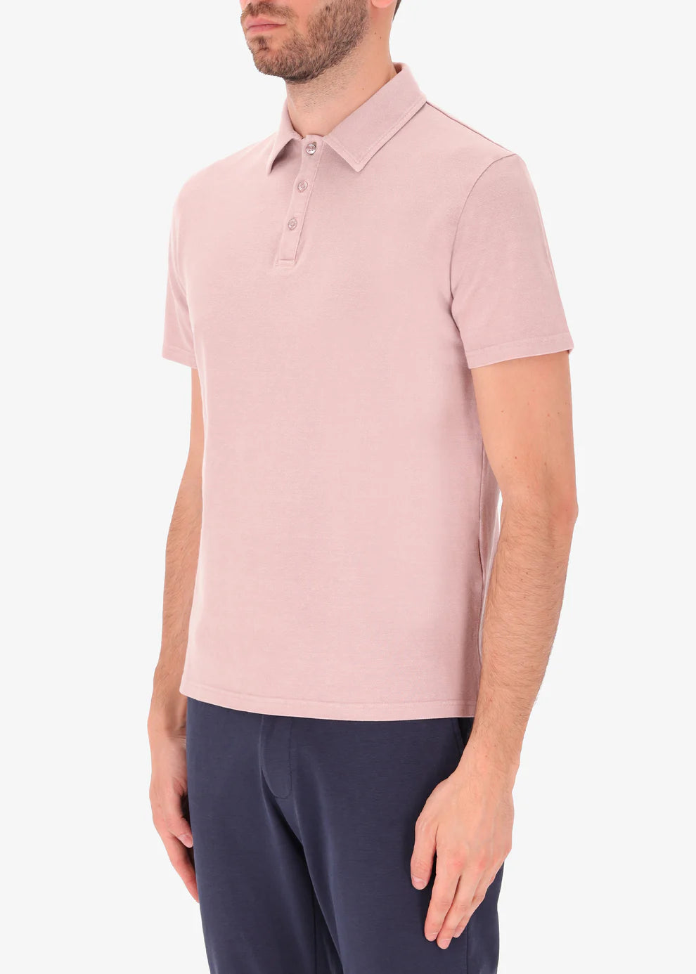 A behind image of a model wearing polo versilia in pink from Distretto 12.