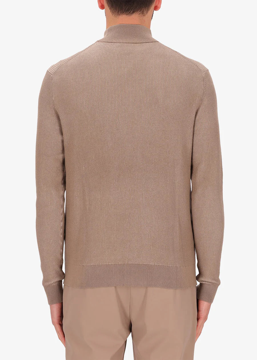 A back facing image of a model wearing Distretto Ribbed neck jumper in brown.