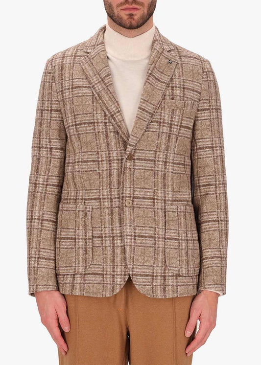 An image of a model wearing a Distretto12 Jacket Osea in camel.