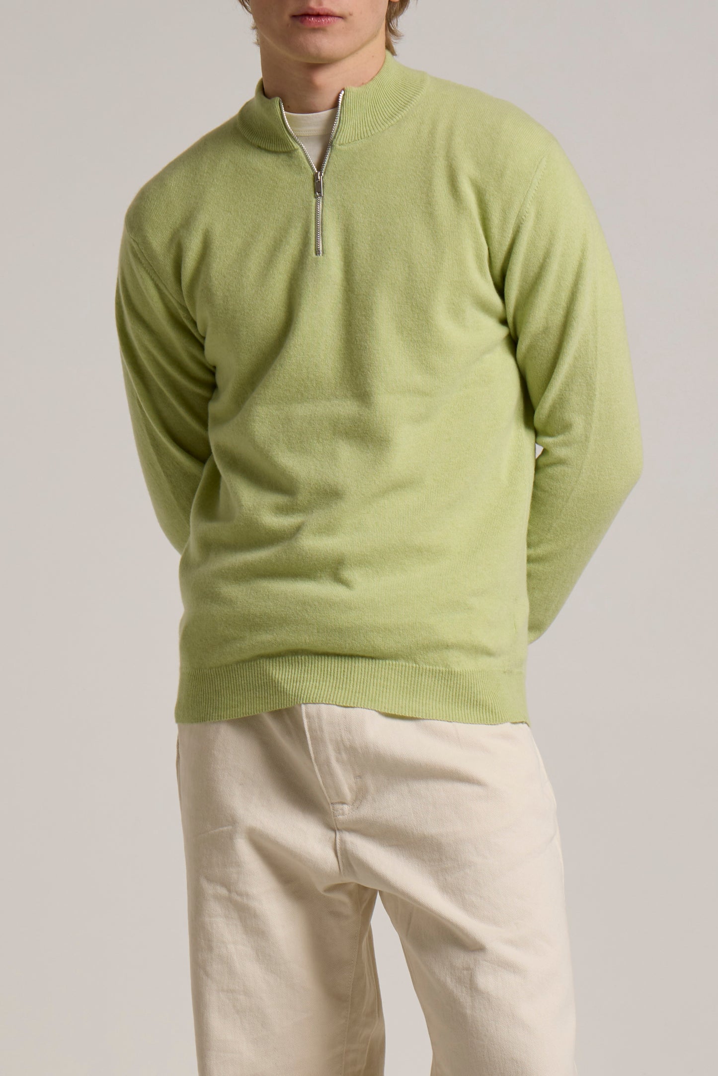 A model wearing a green Wool&Co halfzip knitwear.