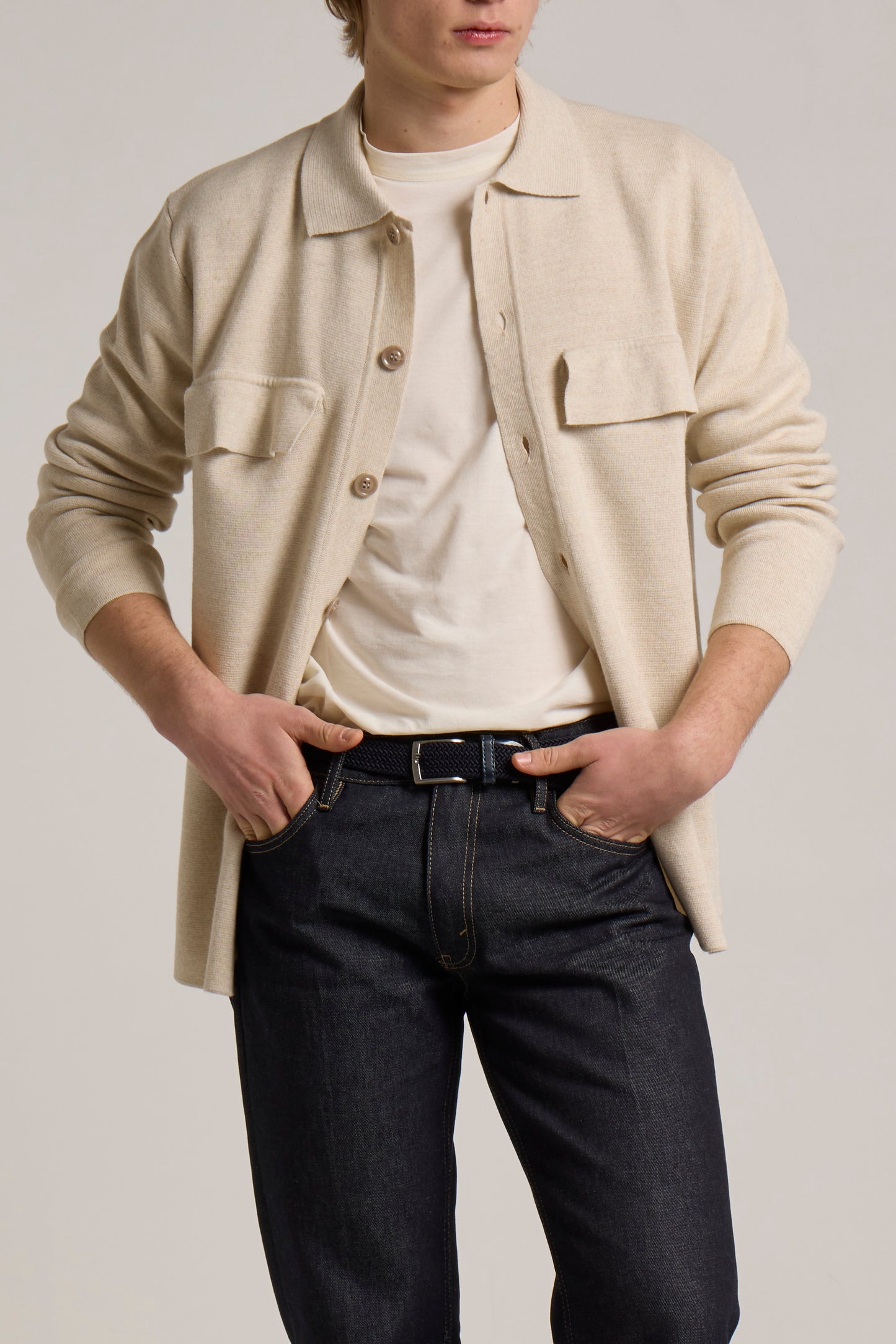 A model wearing a cream knitted Wool&Co jacket.