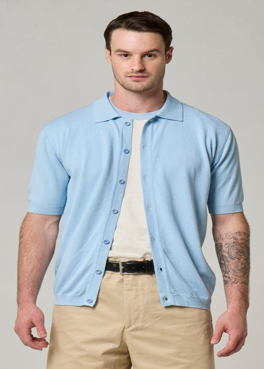 A picture of a model wearing a short sleeve, Wool&Co button up collared cardigan in sky blue.