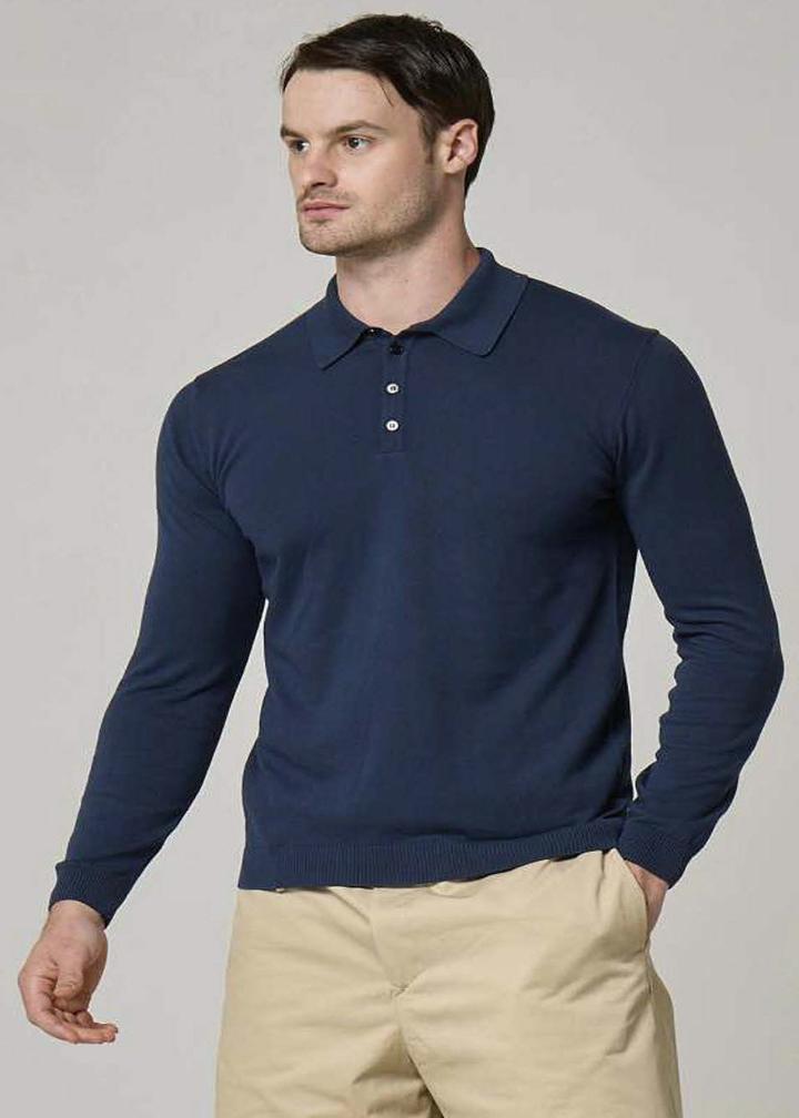 An image of a model Wool&Co wearing long sleeve polo knitwear in cotton.