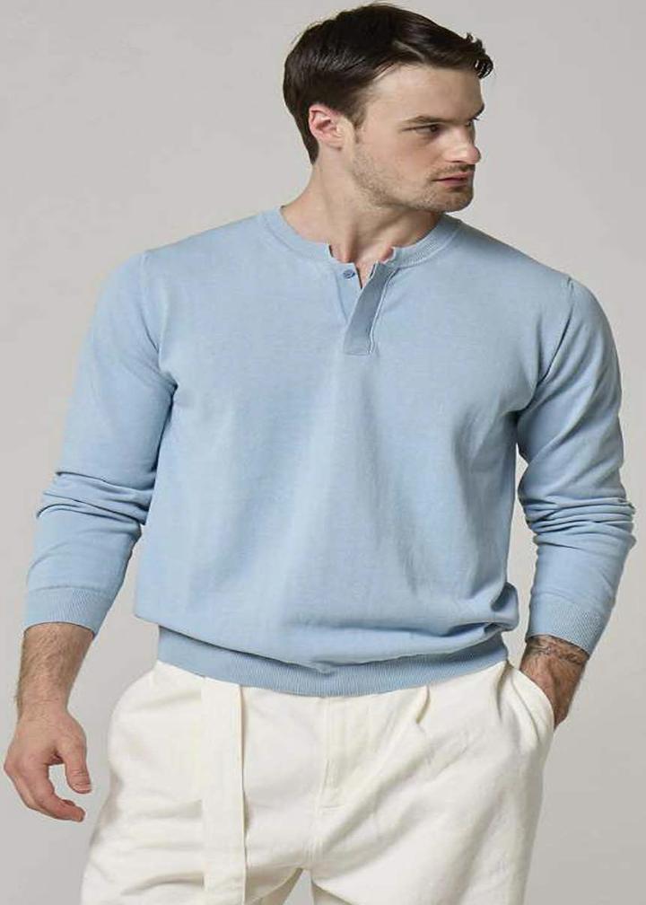 An image of a model wearing a Wool&Co, sky blue cardigan.