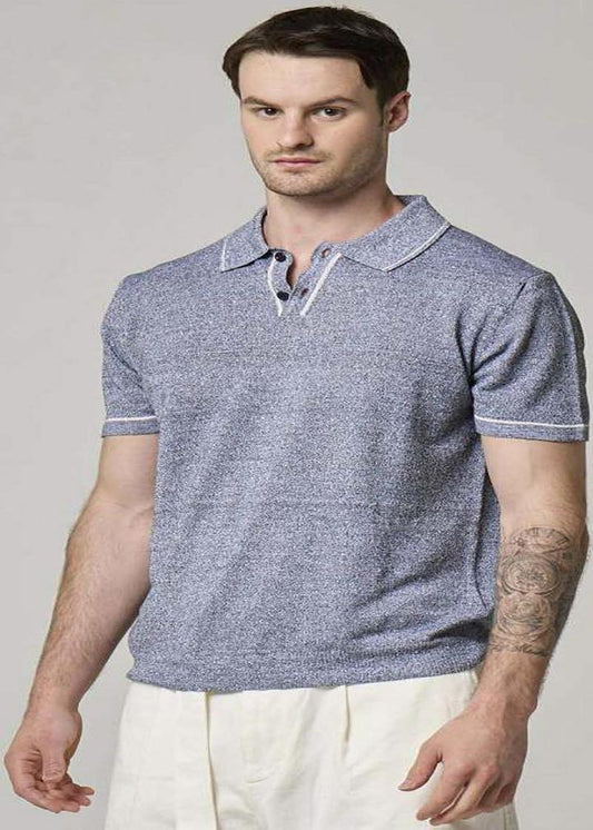 A picture of a model wearing a blue, linen, Wool&Co polo.