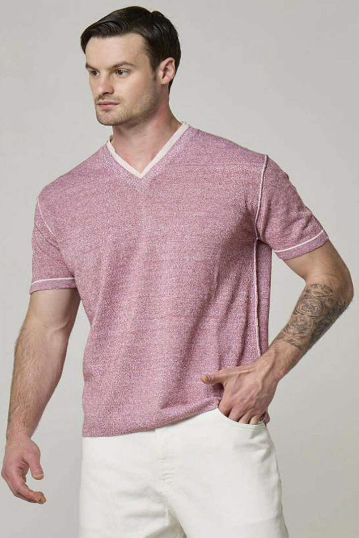 A picture of a model wearing a Wool&Co linen V-neck in red.