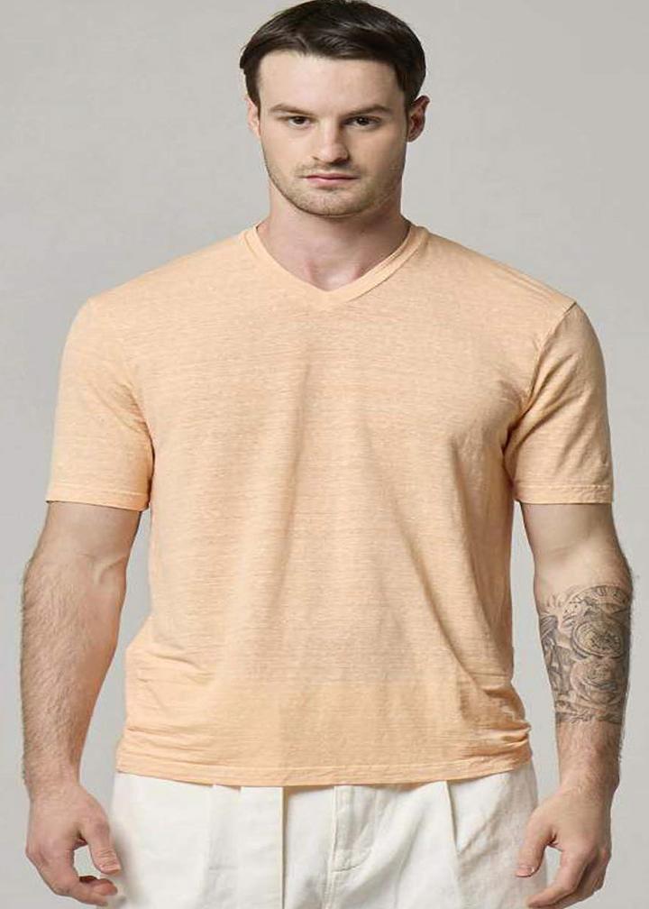 A picture of a model wearing a Wool&Co v-neck in sunset.