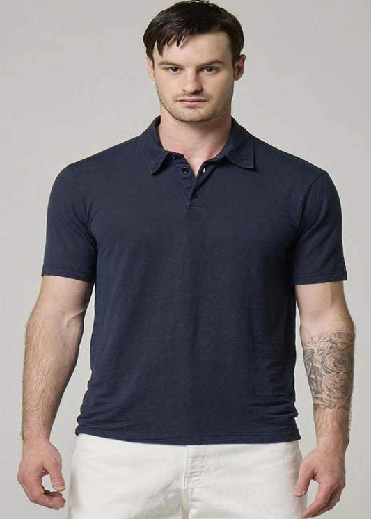 A picture of a model wearing a navy Wool&Co polo.