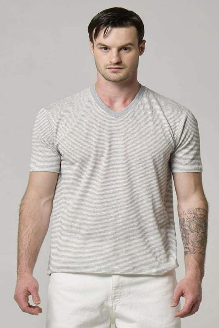 A picture of a model wearing a linen cotton blend v-neck t-shirt in grey & white.
