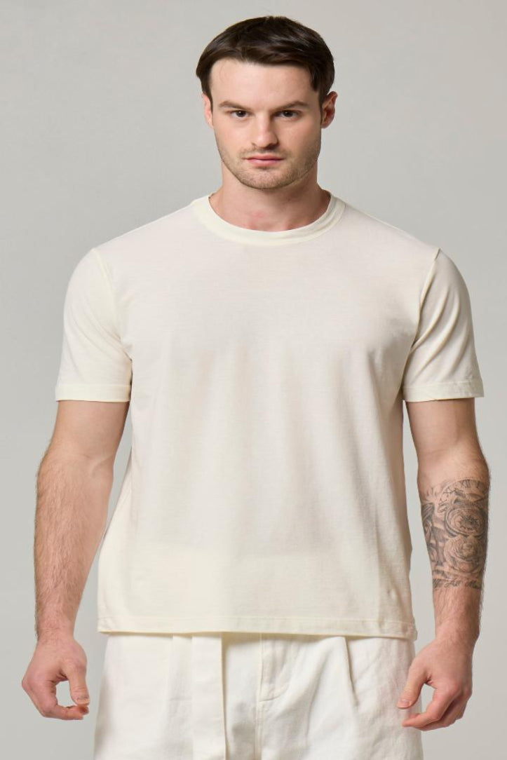 An image of Wool&Co T-shirt in cream worn by model.