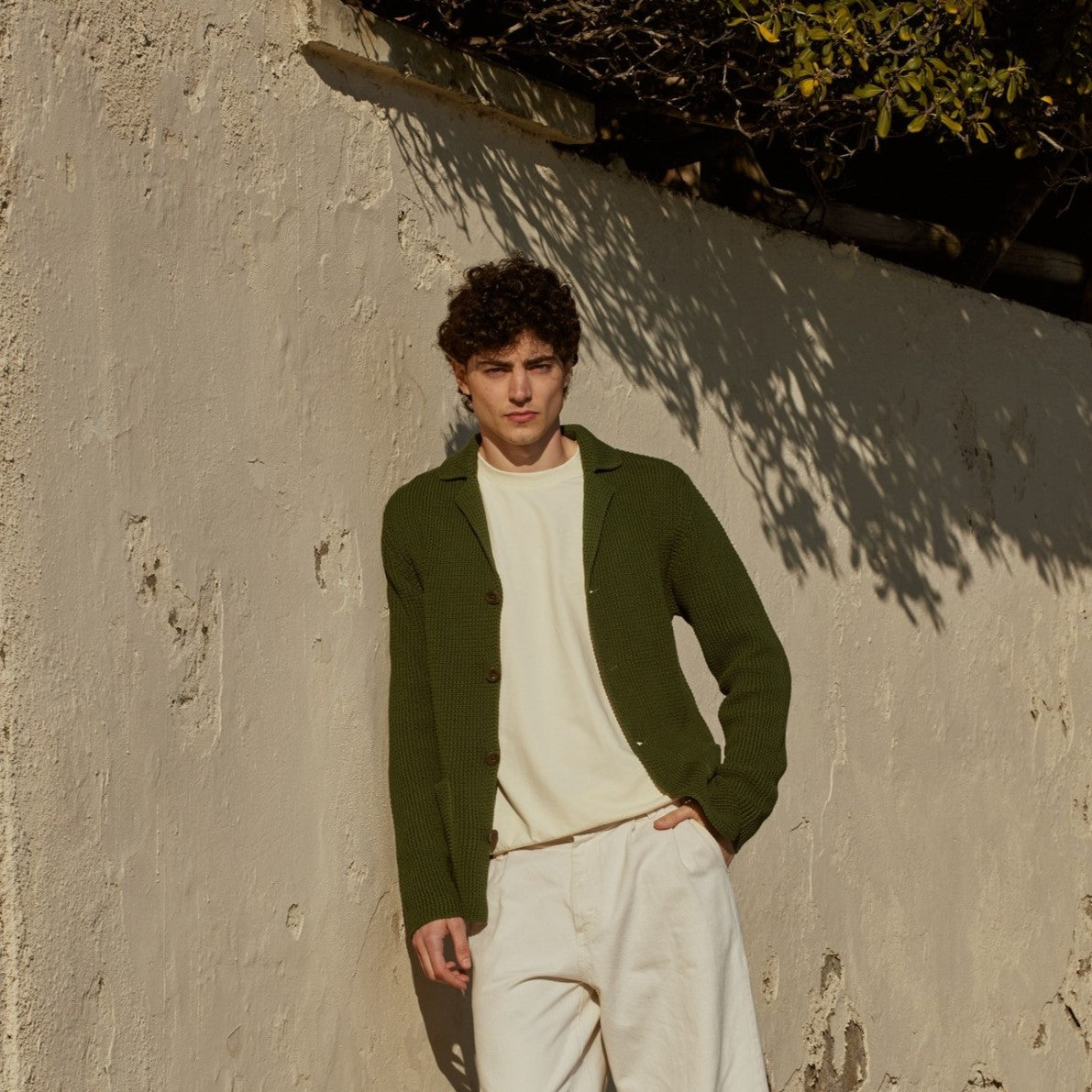 A man wearing a lightweight Wool&Co shirt jacket cardigan.