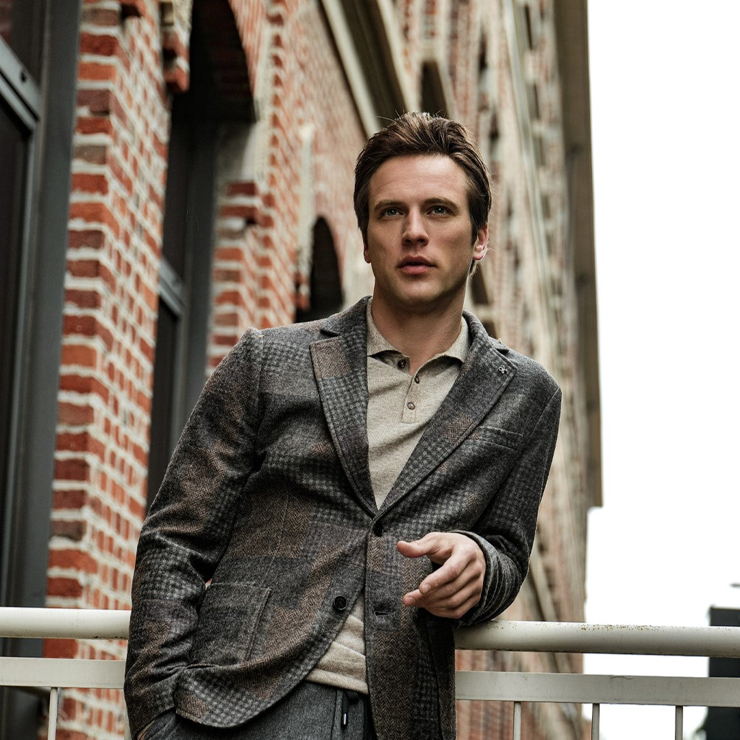 A man wearing Distretto12 wool blend suit in an urban setting.