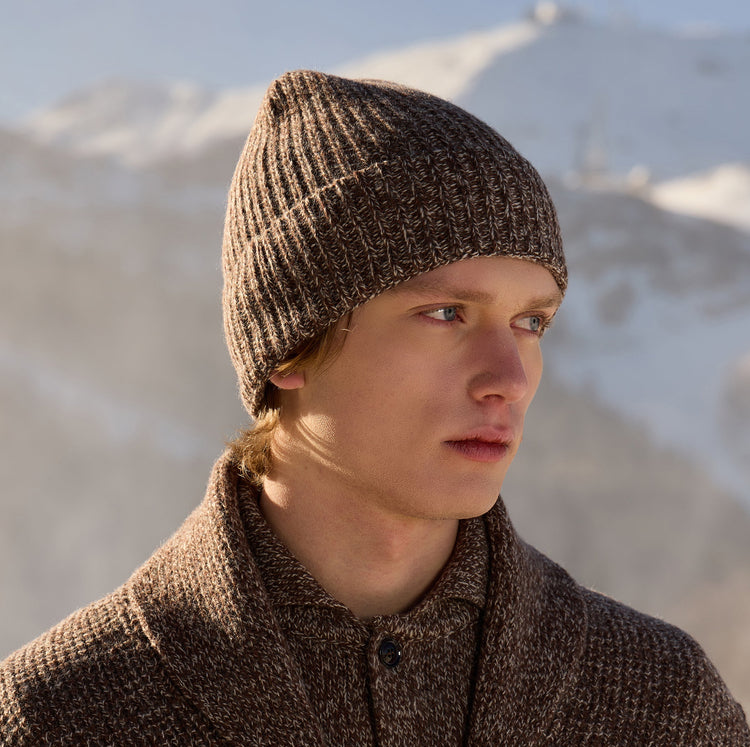 A picture of a man wearing a knitted brown hat