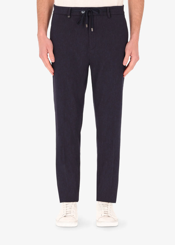 A front facing image of a model wearing the 32 York trousers Saul in blue from Distretto 12.